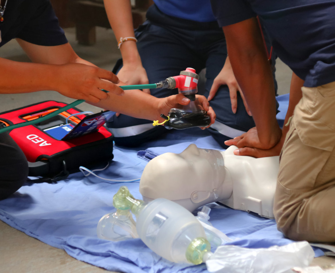 trainees doing cpr on mannequin