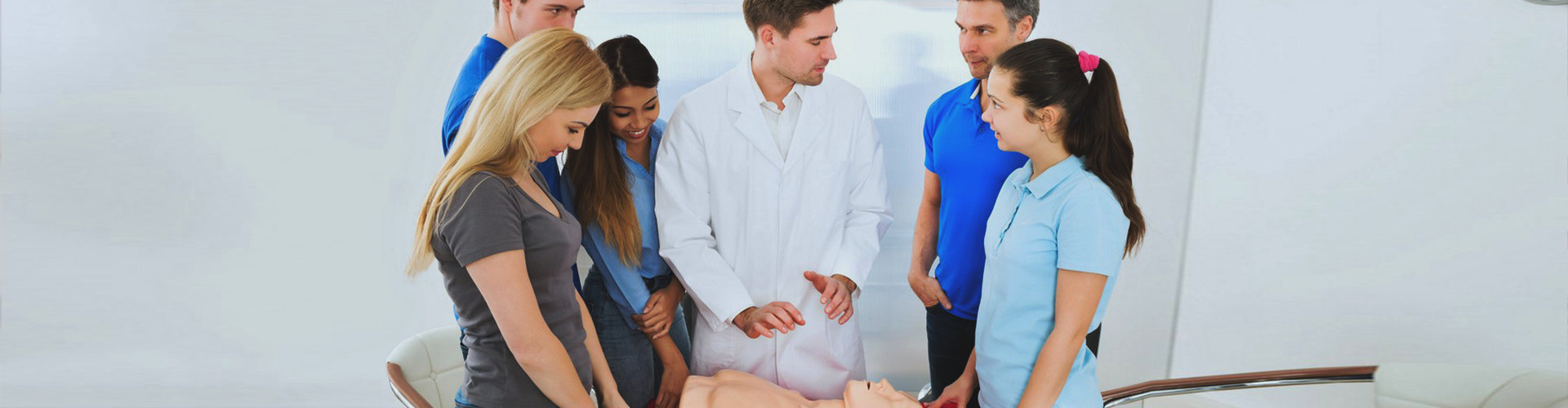 doctor teaches cpr to trainees